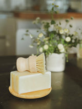 bamboo scrubber brush on a solid dish soap. compostable. zero waste. plastic free. sustainable.