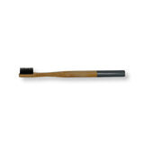 bamboo toothbrush in grey with charcoal infused bristles. compostable. eco friendly.
