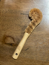 bamboo bottle brush with natural bristles on a wooden table. zero  waste, eco friendly and plastic free