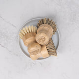 bamboo scrubber brush in a small plate. natural bristles sustainable bamboo. plastic free. zero waste. eco friendly
