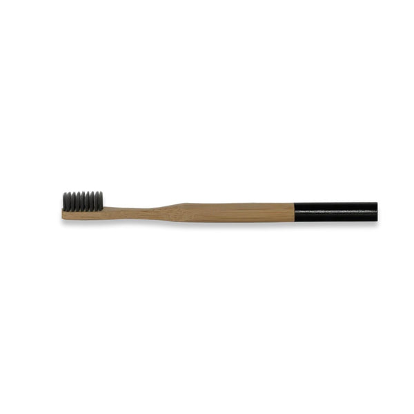 bamboo toothbrush with charcoal infused bristles . compostable. sustainable. 